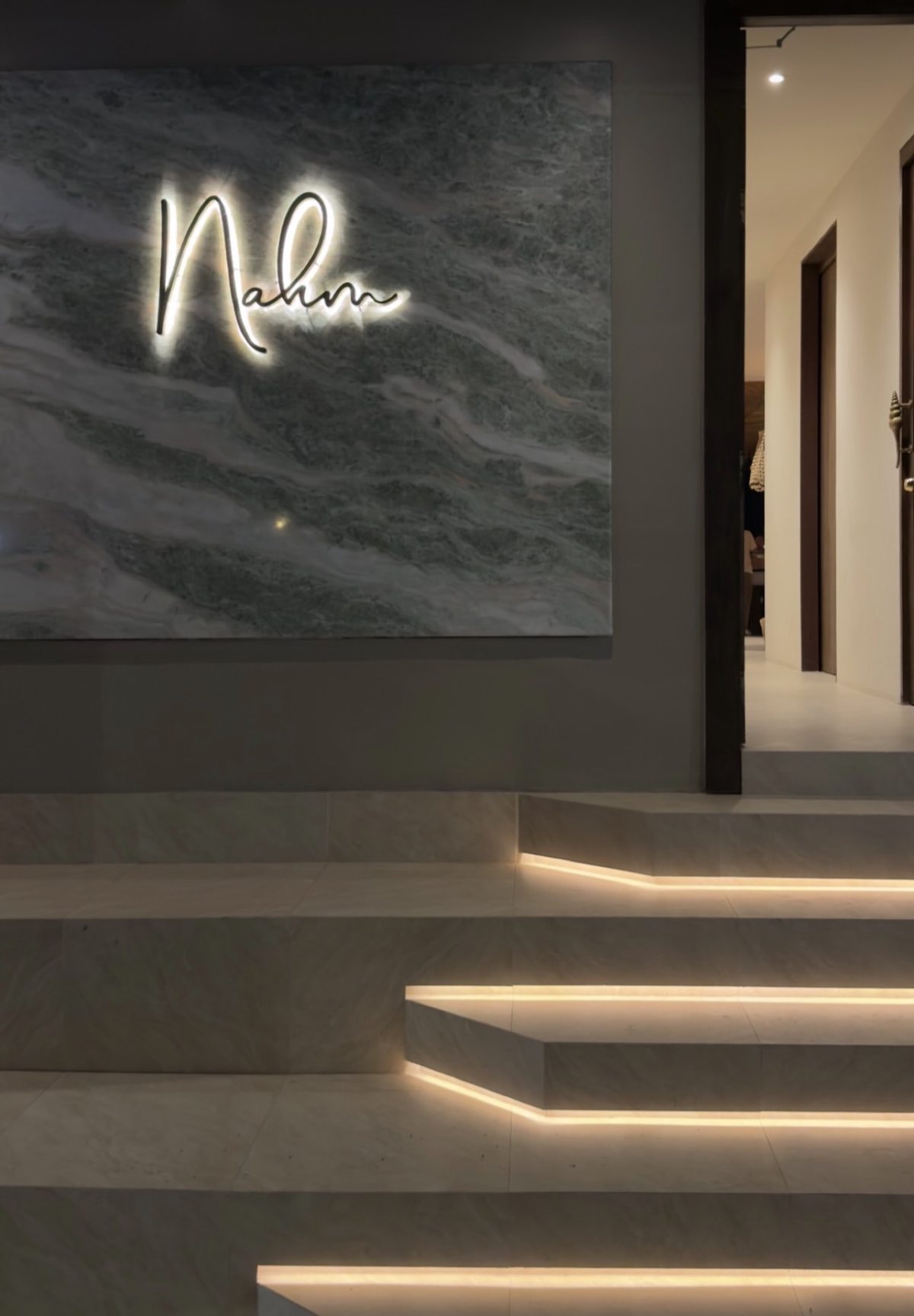 Nahm's illuminated entrance sign and staircase at night, Bangrak, Koh Samui