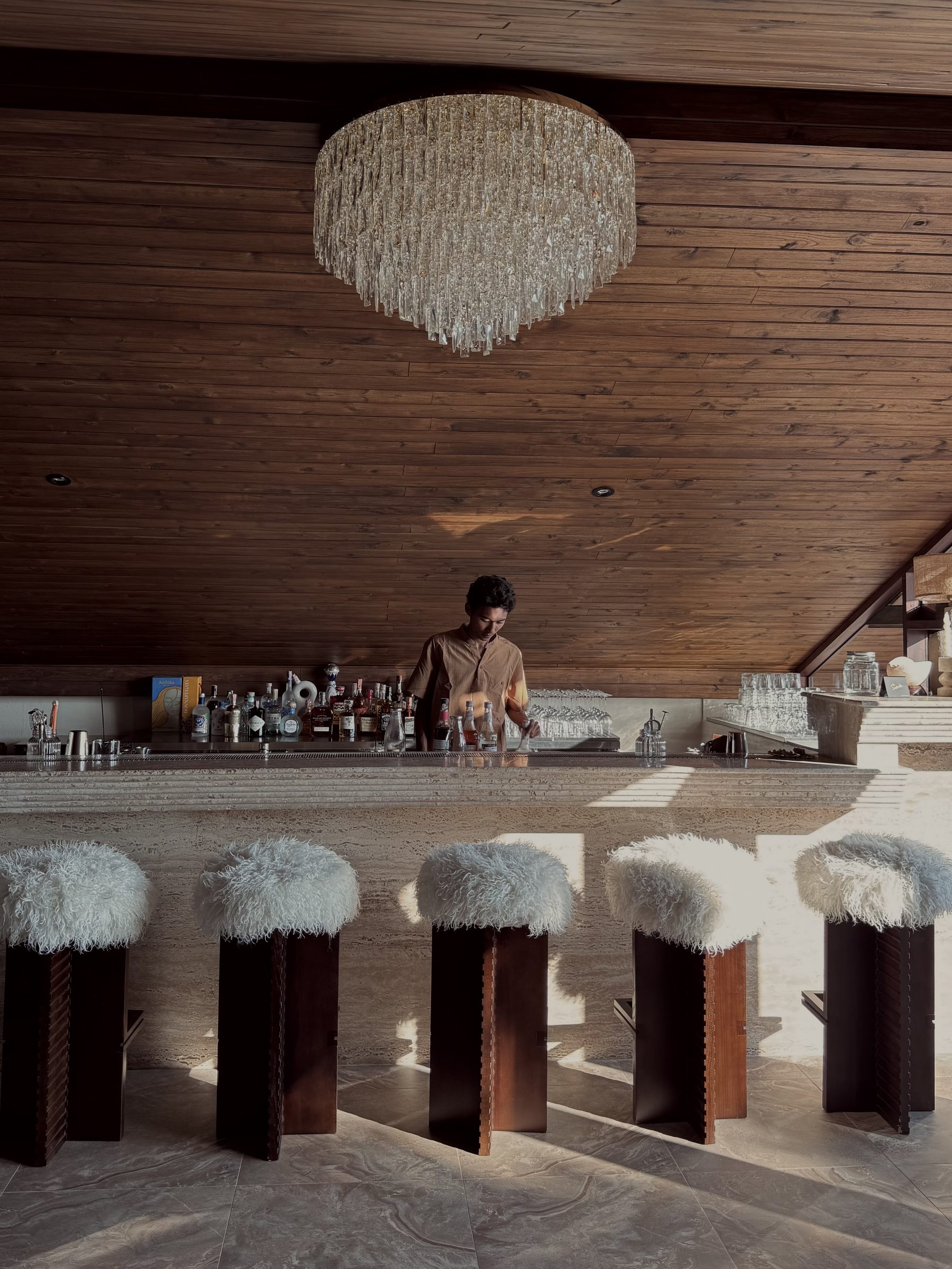 The bar at Soirée under its crystal chandelier, Bangrak